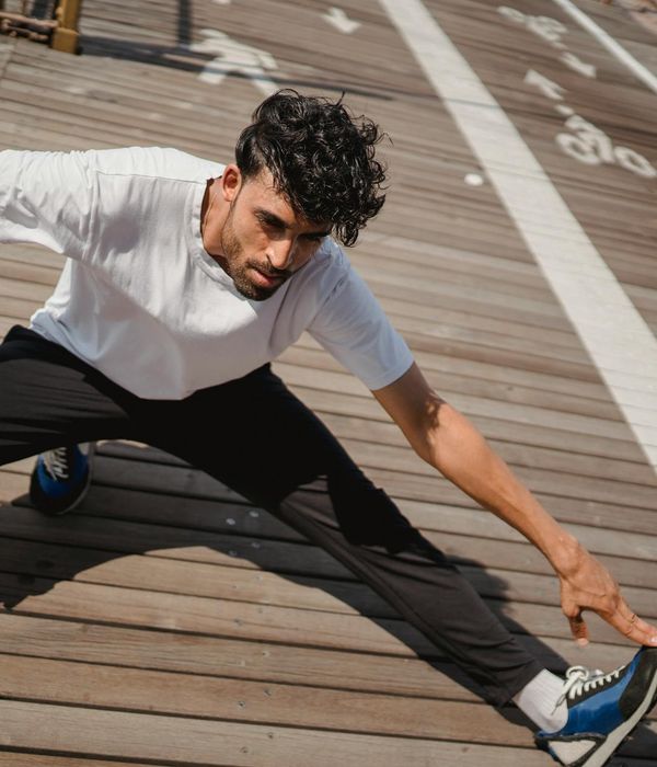 Man stretching outdoors feeling revitalized and focused.
